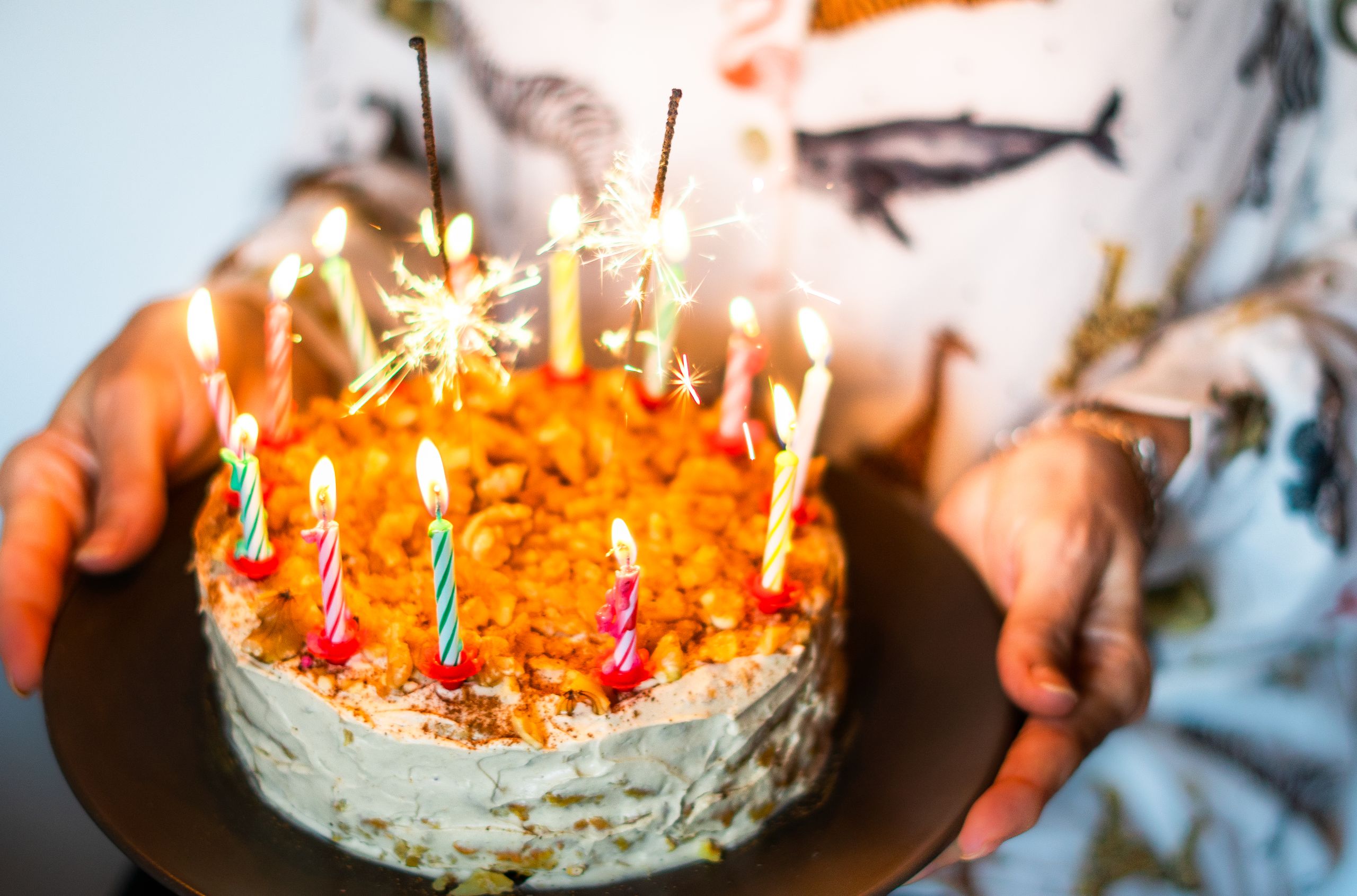 Colorful birthday cake with candles and sparklers, perfect for celebrations.