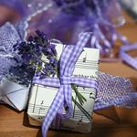 A beautifully wrapped gift box with lavender and musical sheet, ideal for romantic or rustic occasions.