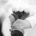 Close-up of a couple's hands with rings, symbolizing marriage and love.